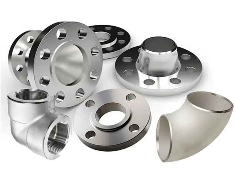 Various metal pipe fittings and flanges arranged on a white surface.
