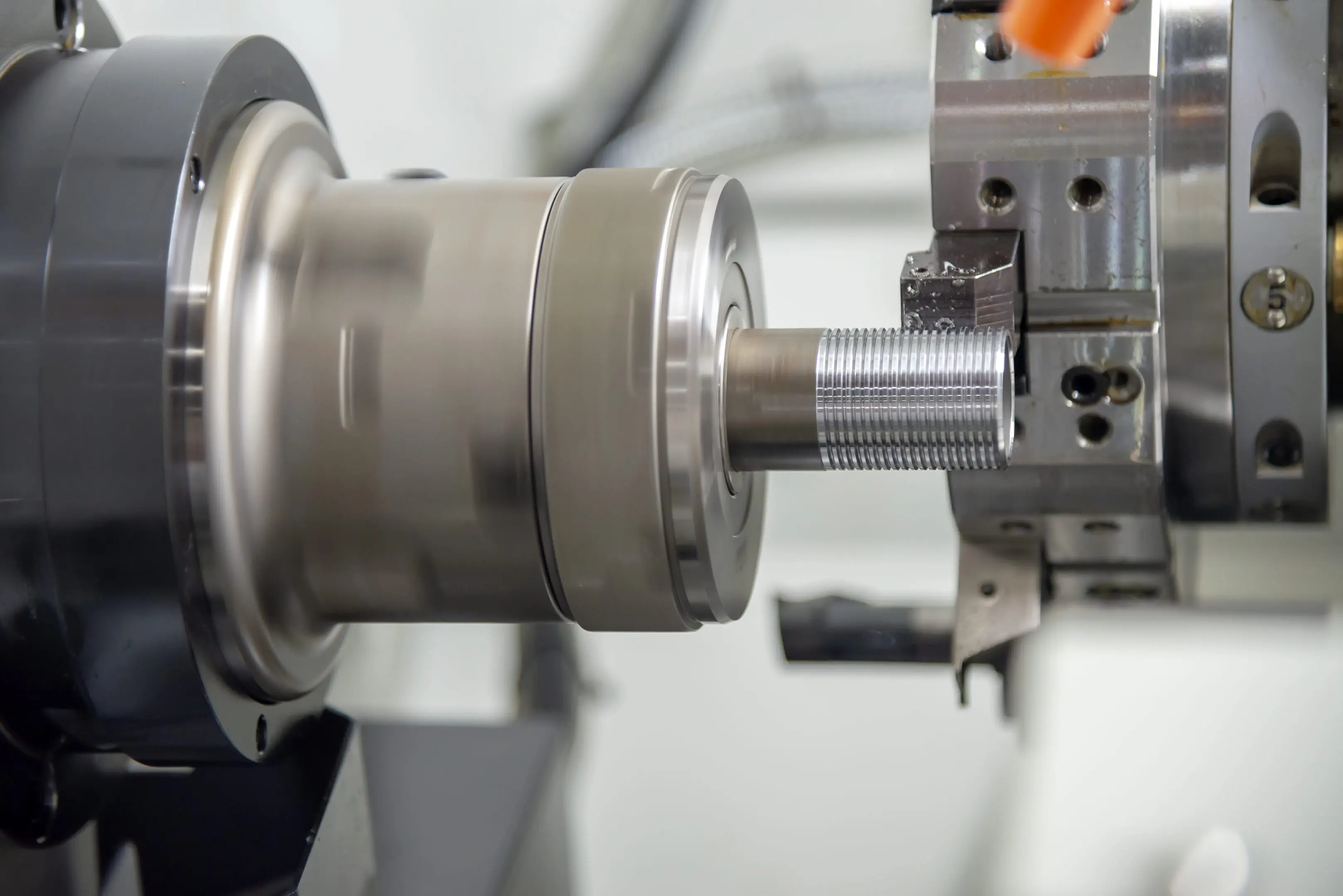 CNC lathe machine turning a metal workpiece.