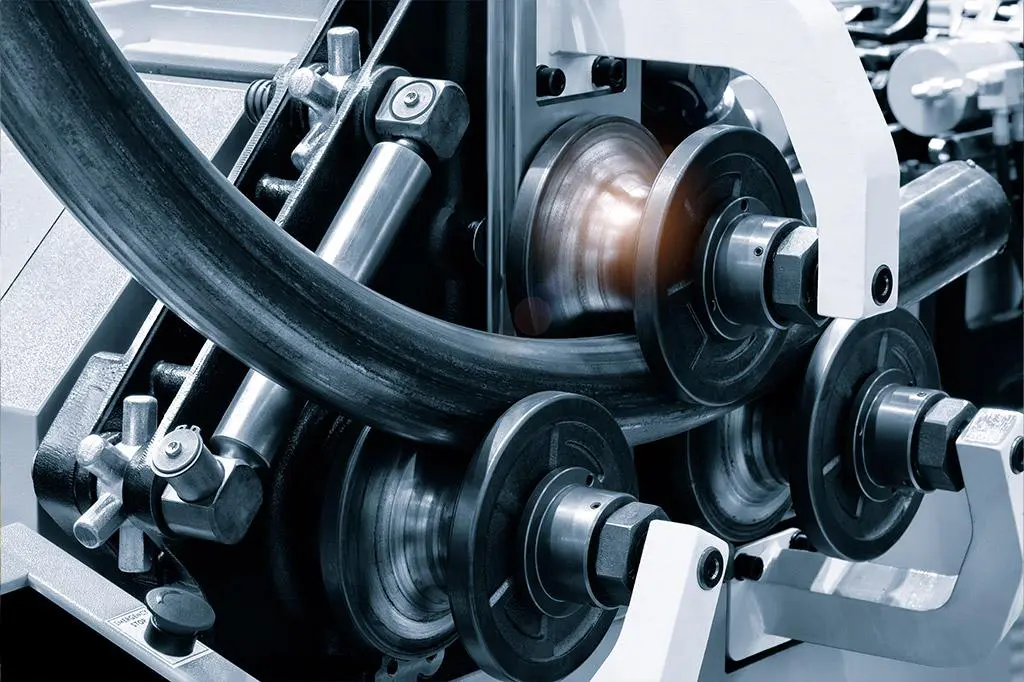 Close-up of mechanical gears and belts in a machine.
