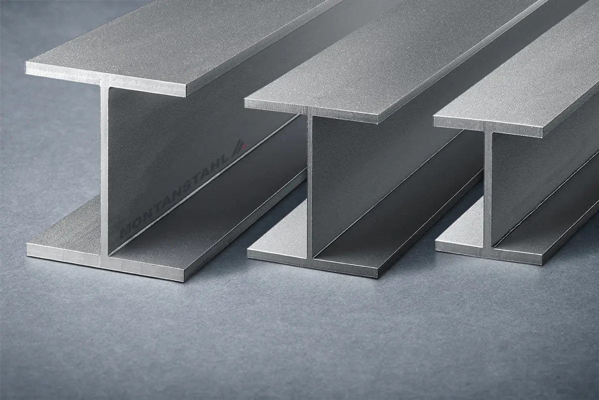 Three steel I-beams arranged parallel on a grey surface.