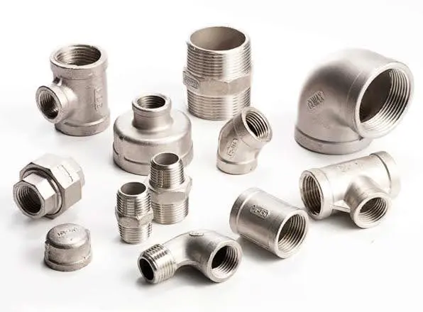 Various stainless steel pipe fittings arranged on a white surface.