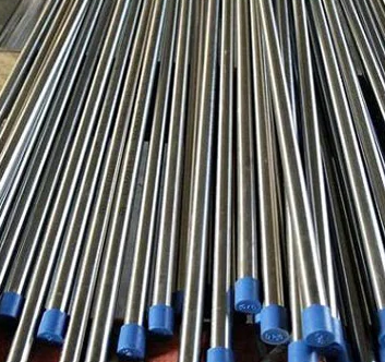 Stack of long metal rods with blue ends.
