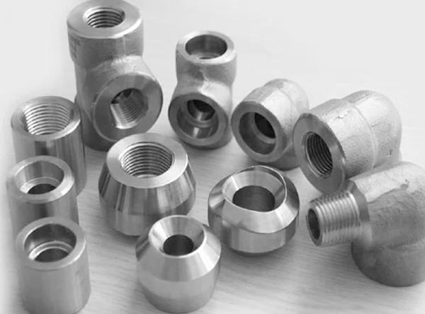 Various metallic machined parts with threaded holes.